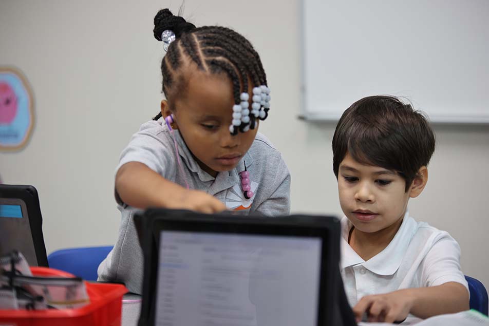 student in classroom smiling at camera