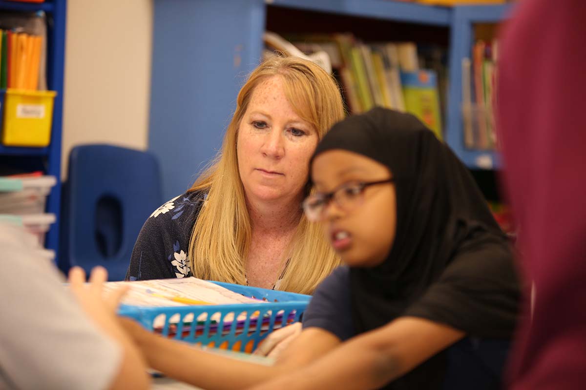 Student drawing in a classroom.